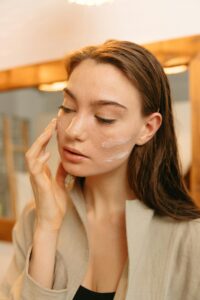 woman applying moisturizer